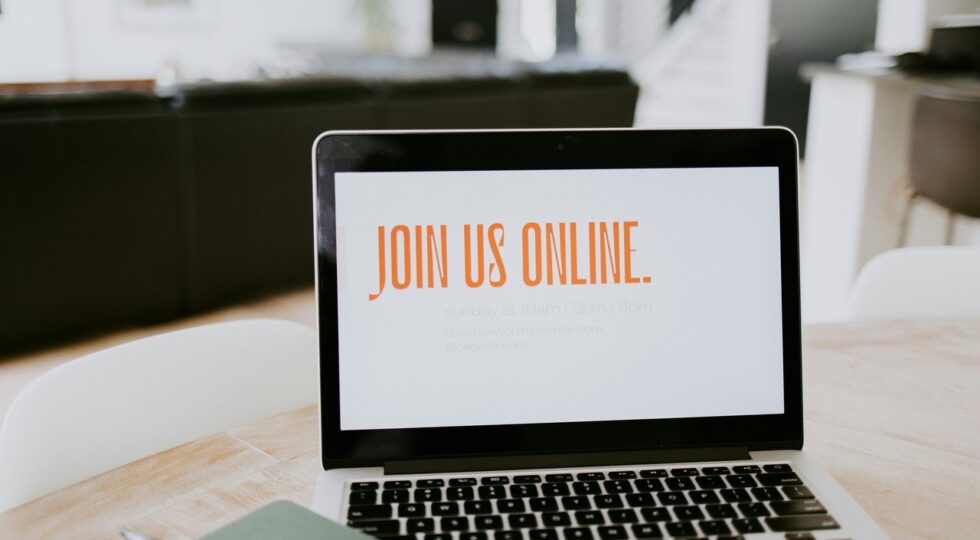 a landing page for the webinar appearing in the laptop screen